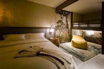 A room with a bed and a bed and a bed and a bed Description automatically generated
