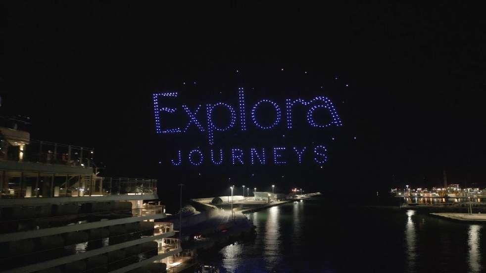 A lit up blue letters on a black background

Description automatically generated