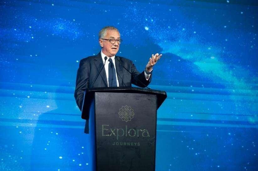 A person standing at a podium

Description automatically generated