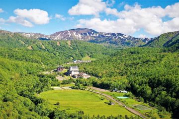 A landscape with trees and mountains in the background AI-generated content may be incorrect.