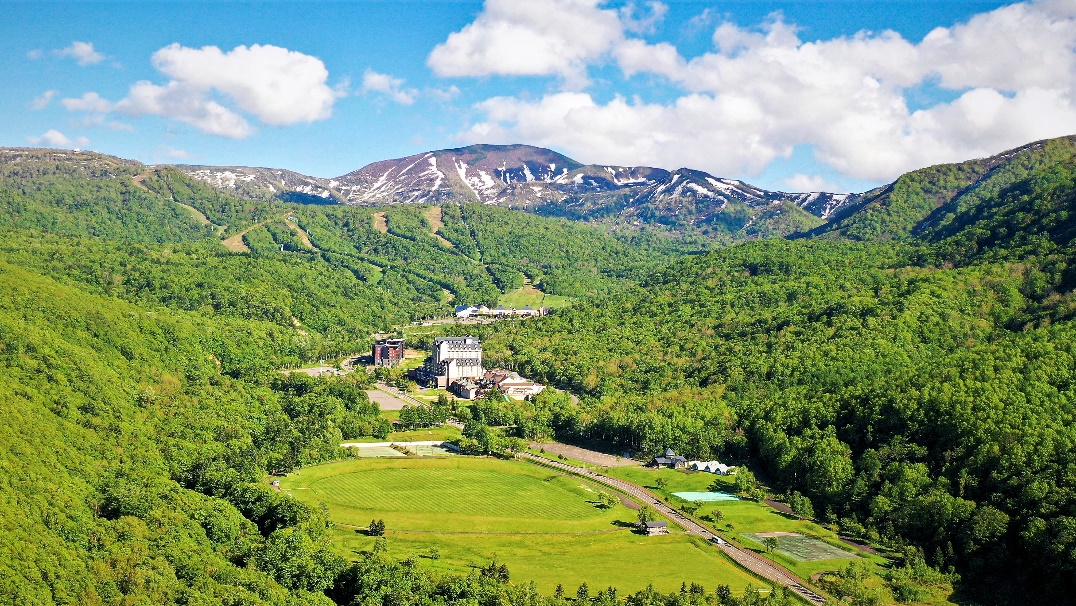 A landscape with trees and mountains in the background AI-generated content may be incorrect.