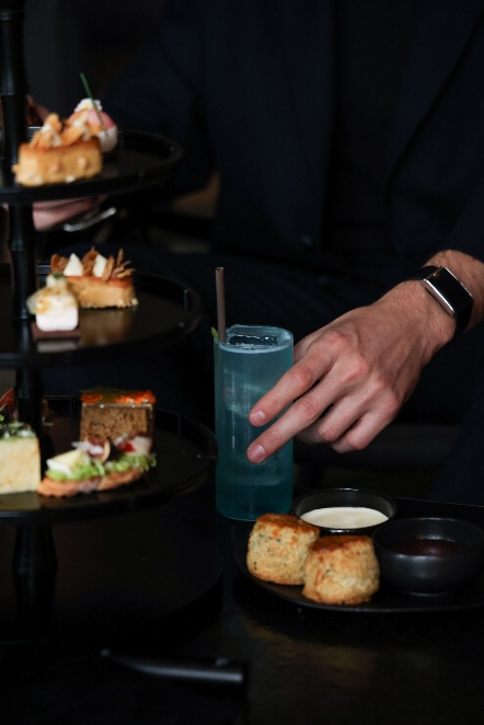 A hand holding a drink Description automatically generated